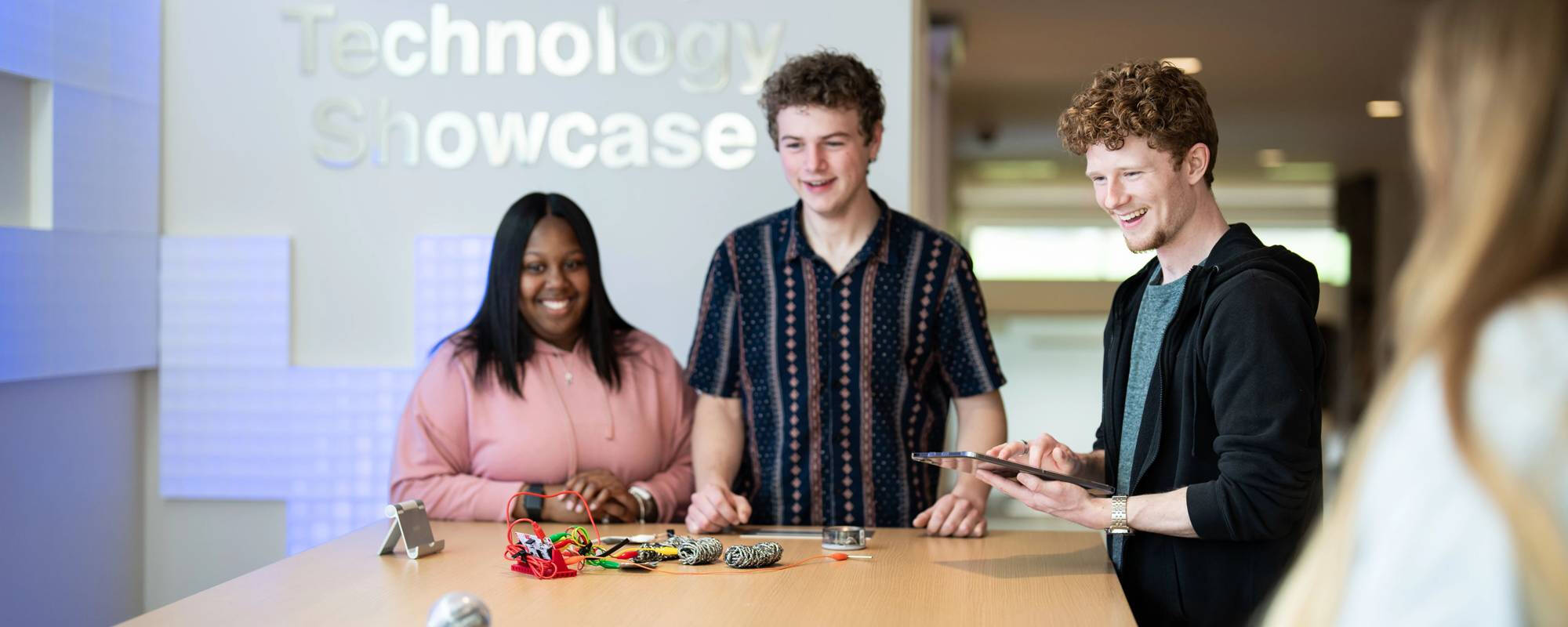 Students displaying projects at Technology Showcase